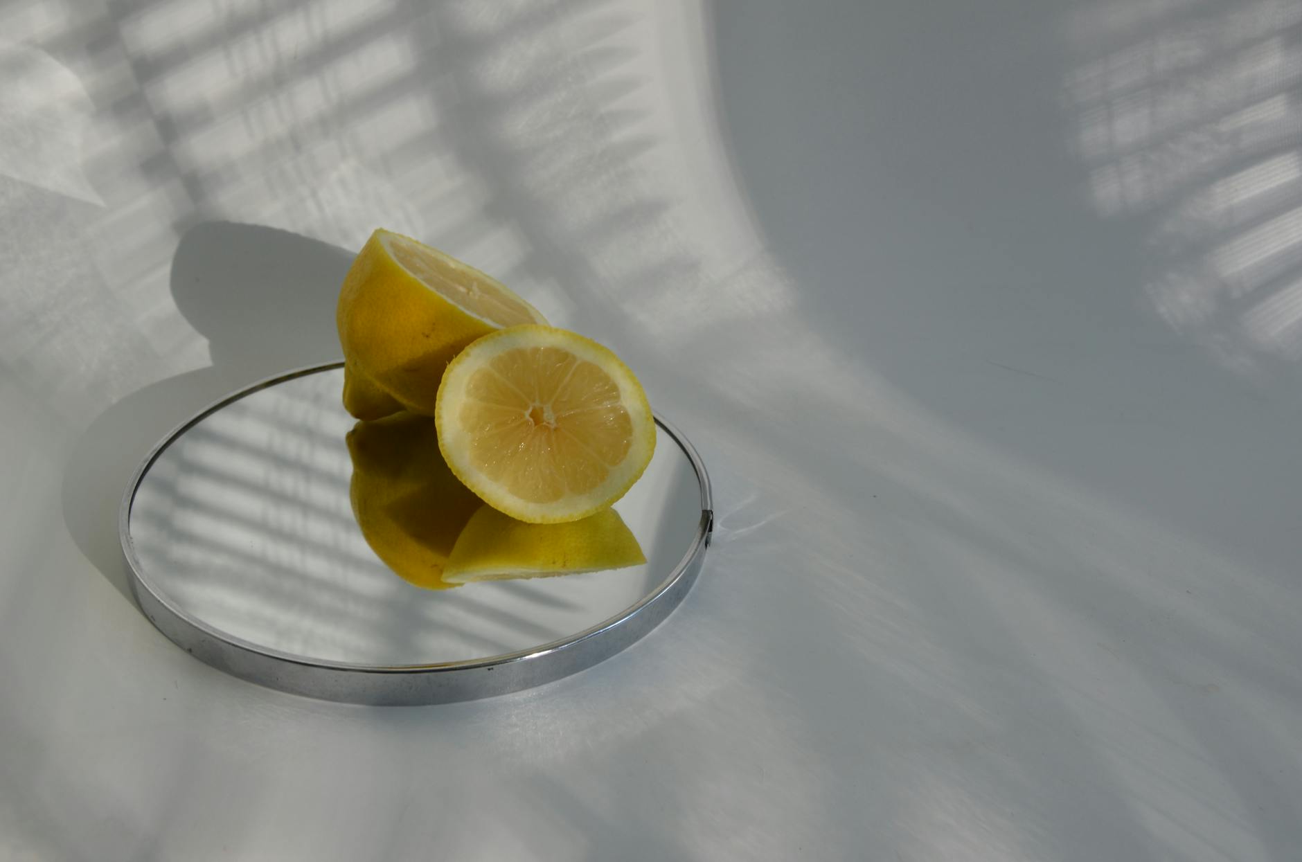 Hand holding a blue silicone lemon vibrator, showcasing the smooth design against a purple background