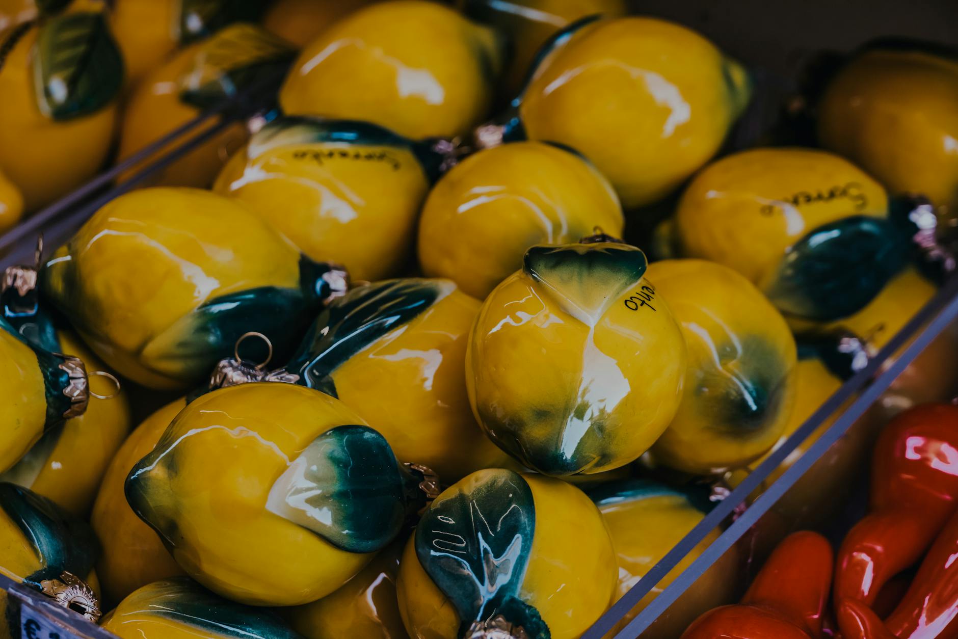 Vibrant yellow ceramic lemons artfully displayed, symbolizing the citrus-inspired design of modern clitoral vibrators