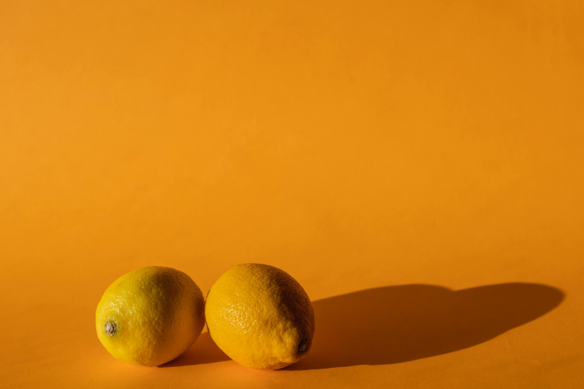 Ripe vivid lemons composed on yellow background